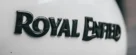 Detailed shot of a Royal Enfield motorcycle tank showcasing the iconic logo.